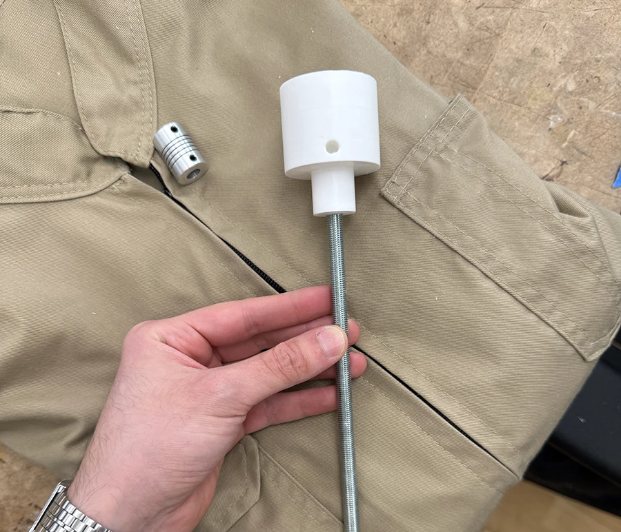 3D printed part on top of a threaded rod.
