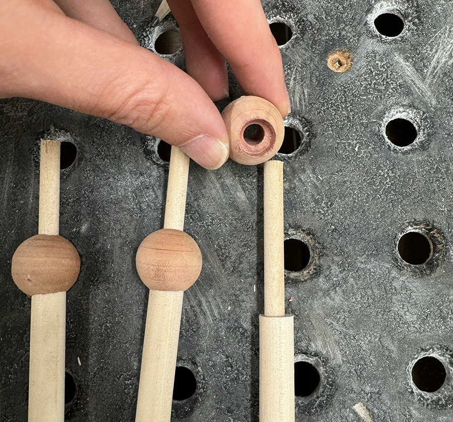 6 dowels, each going through a wood sphere.