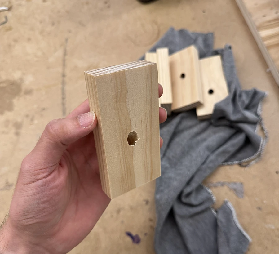 5 blocks of wood with a hole.