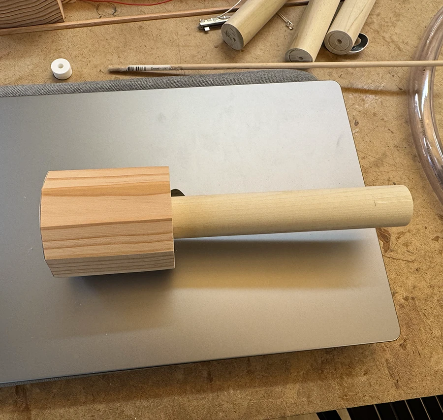 Wooden dowel inserted into a wooden decagonal prism.