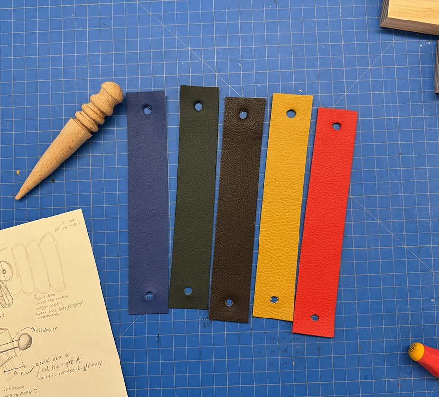 5 leather strips with holes on the ends.