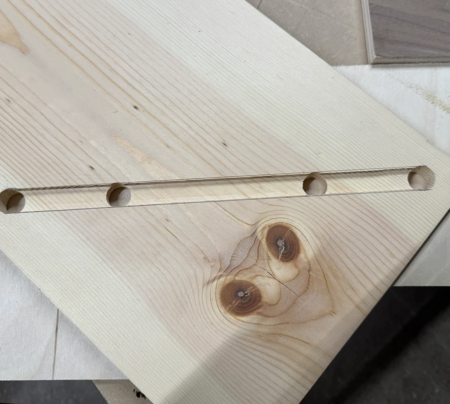 A plank of wood with a channel running across it.