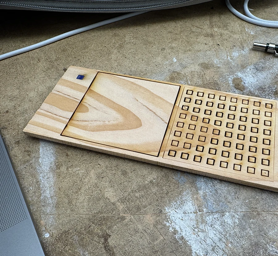 Square grid etched with laser onto a wooden plank.