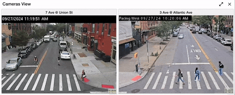 Animated gif showing one person passing an umbrella to another person across two separate frames.
